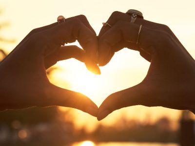 people-making-heart-with-hands-sunset (1)