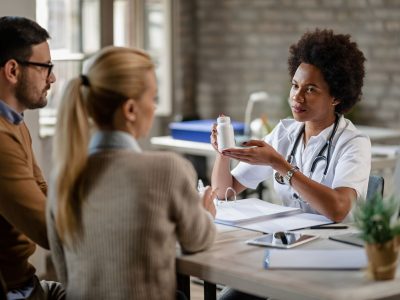 young-couple-receiving-prescription-medicine-from-female-doctor-consultations-clinic-focus-is-doctor (1)