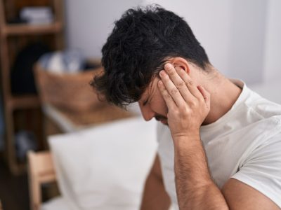 young-hispanic-man-suffering-backache-sitting-bed-bedroom (1)